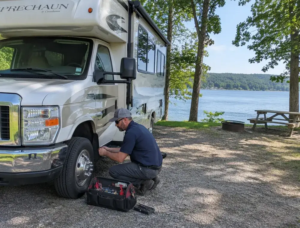 On-Site RV Repair Service Near Smithville Lake RV technician beside a Class C motorhome at a campsite near Smithville Lake in the Kansas City Northland